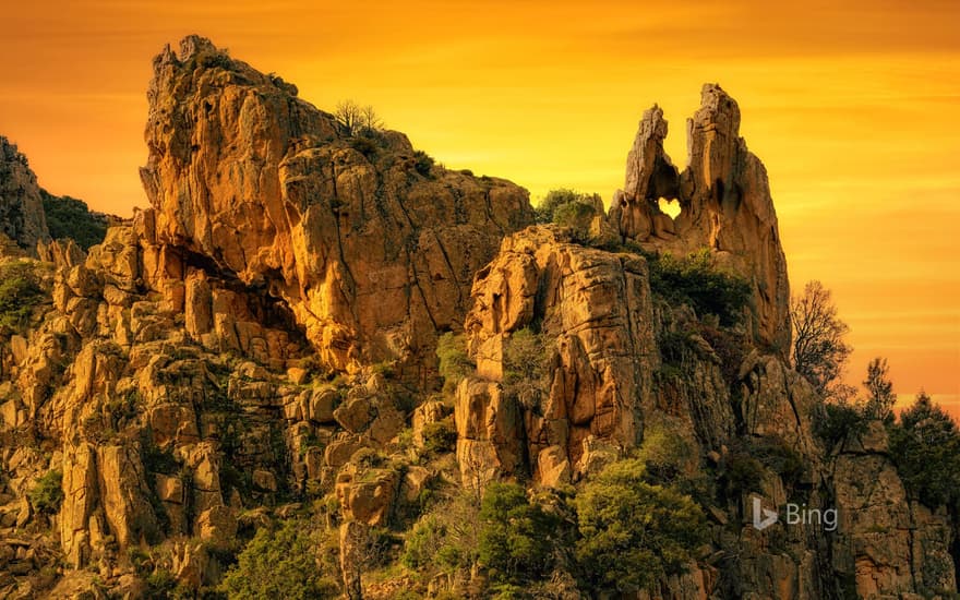 A heart-shaped hole in the rock formation of Calanques de Piana in Corsica, France