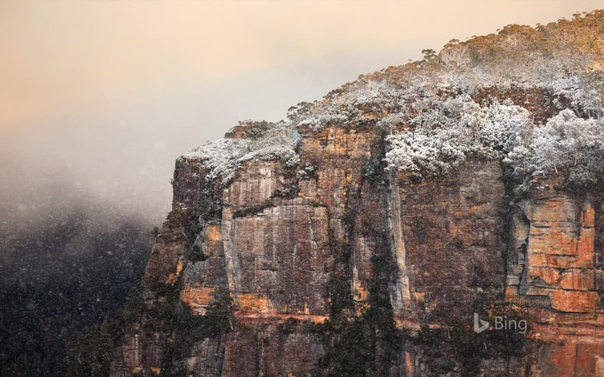 A snow-covered rocky cliff at Echo Point lookout, Katoomba, New South Wales